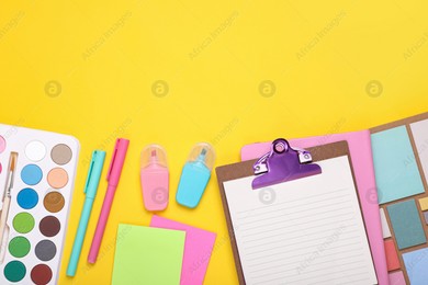 Flat lay composition with different school stationery on yellow background, space for text. Back to school Photo of Flat lay composition with different school stationery on yellow background, space for text. Back to school
