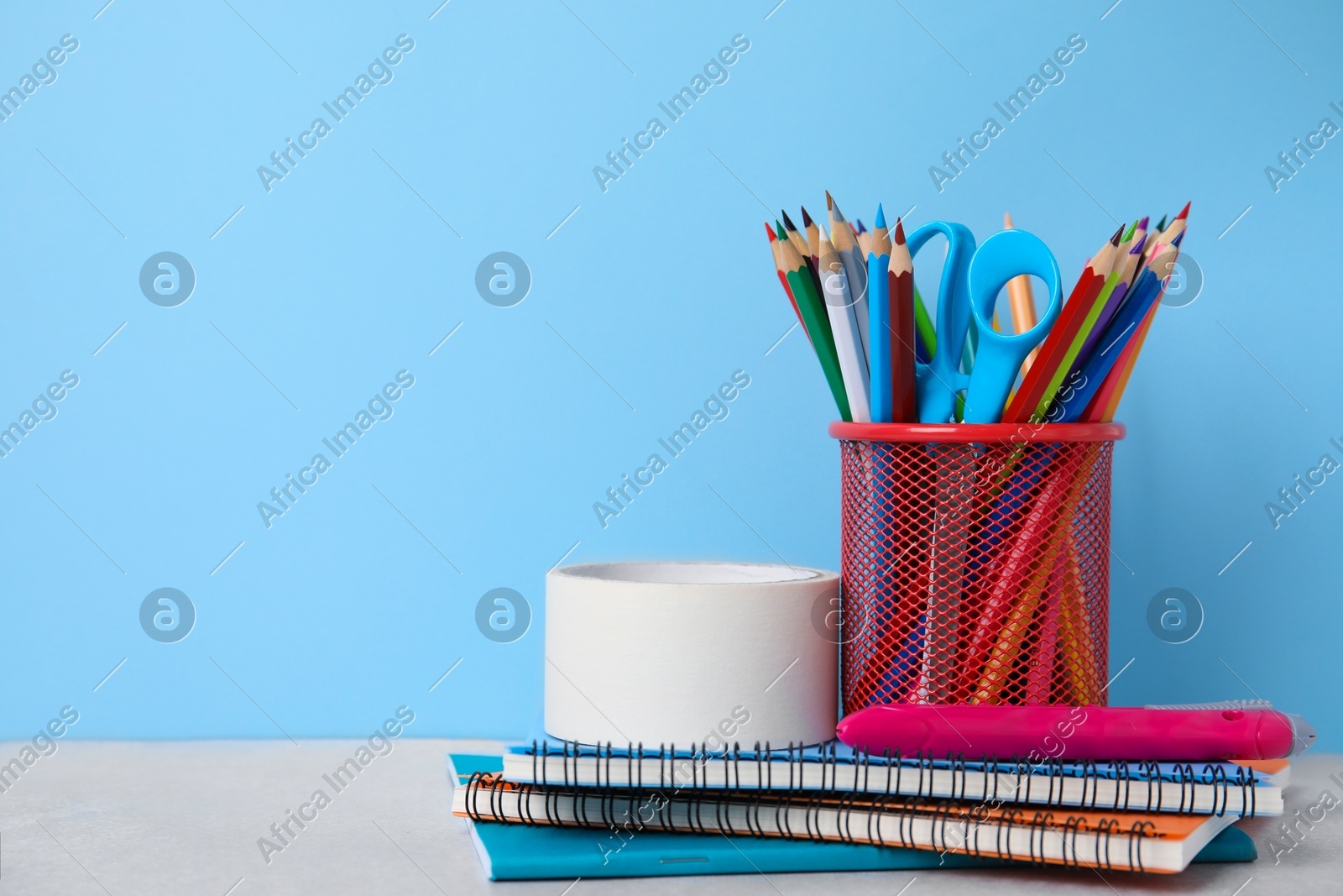 Different school stationery on table against light blue background, space for text. Back to school Photo of Different school stationery on table against light blue background, space for text. Back to school