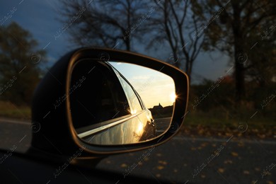 Side view mirror of car outdoors at sunset, closeup Photo of Side view mirror of car outdoors at sunset, closeup