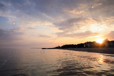 Picturesque view of sea and coast at sunset Photo of Picturesque view of sea and coast at sunset