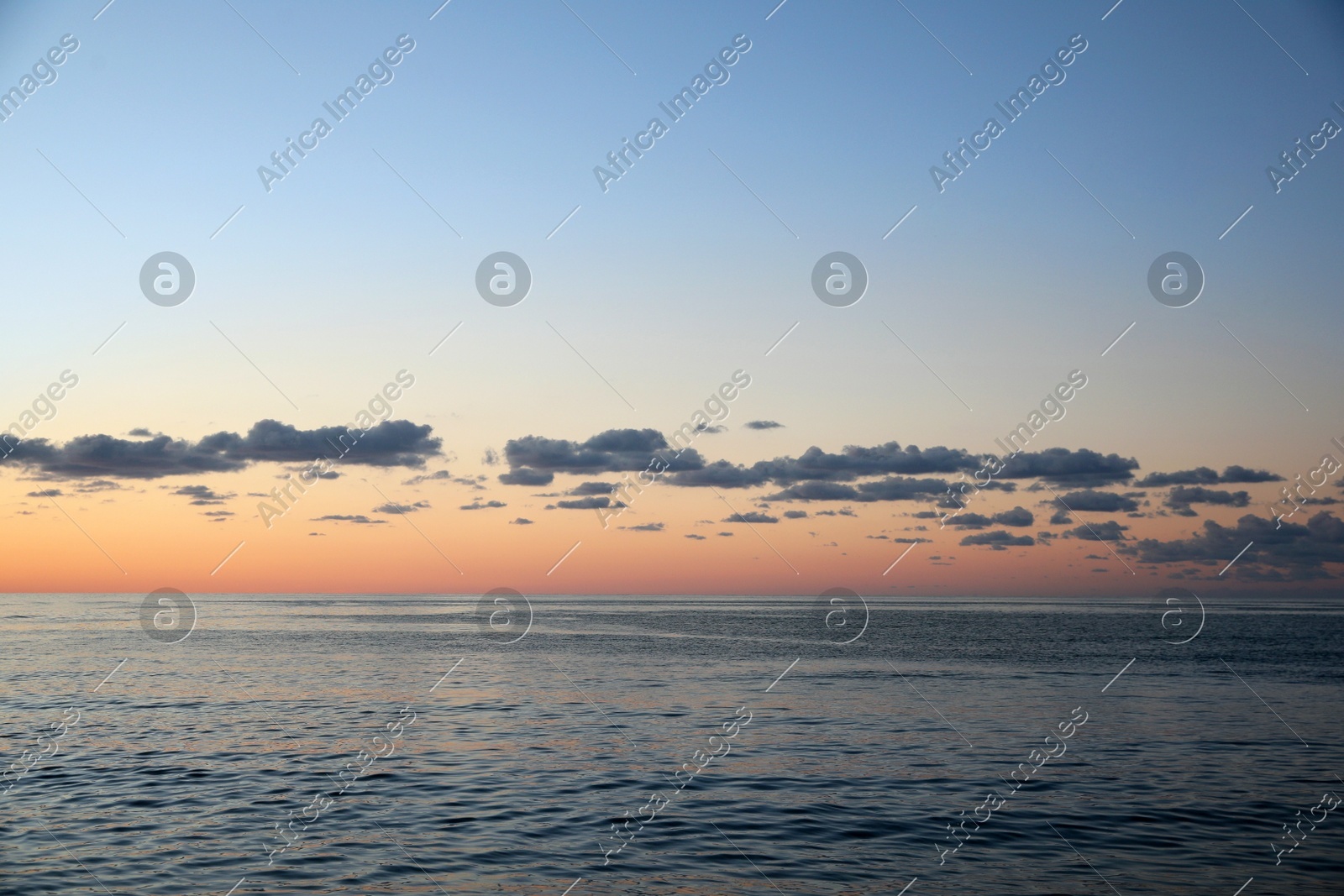 Picturesque view of sea under beautiful sky at sunset Photo of Picturesque view of sea under beautiful sky at sunset