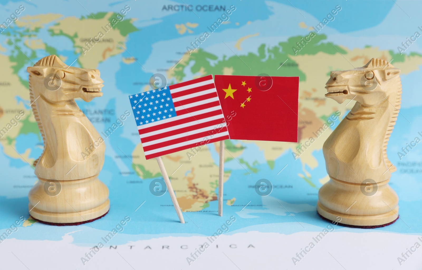 Chess pieces, American and Chinese flags on world map. Trade war concept Photo of Chess pieces, American and Chinese flags on world map. Trade war concept