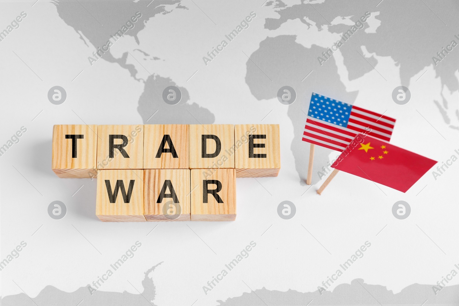 Words Trade War made of wooden cubes, American and Chinese flags on world map, above view Photo of Words Trade War made of wooden cubes, American and Chinese flags on world map, above view