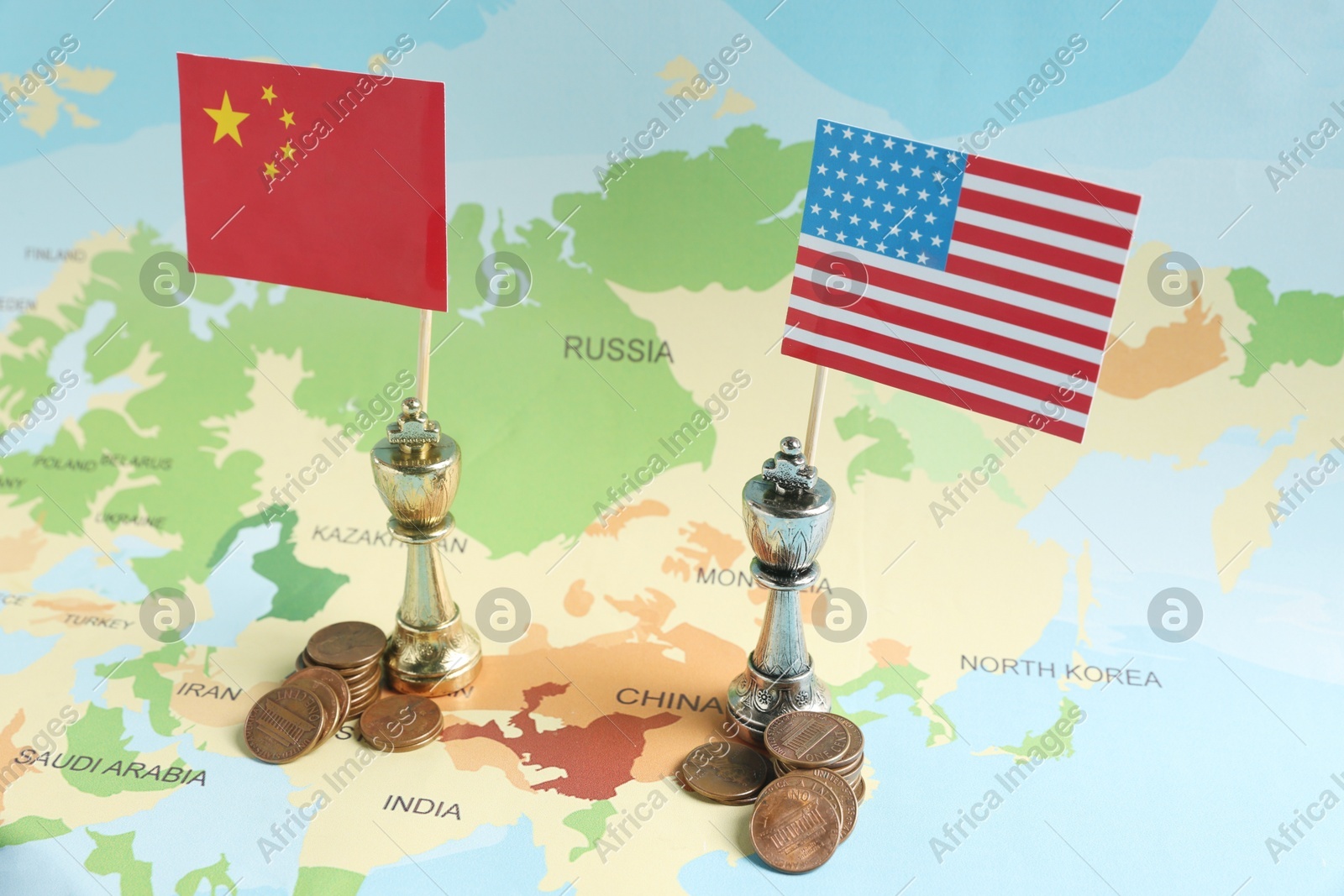 Chess pieces with American and Chinese flags and coins on map. Trade war Photo of Chess pieces with American and Chinese flags and coins on map. Trade war