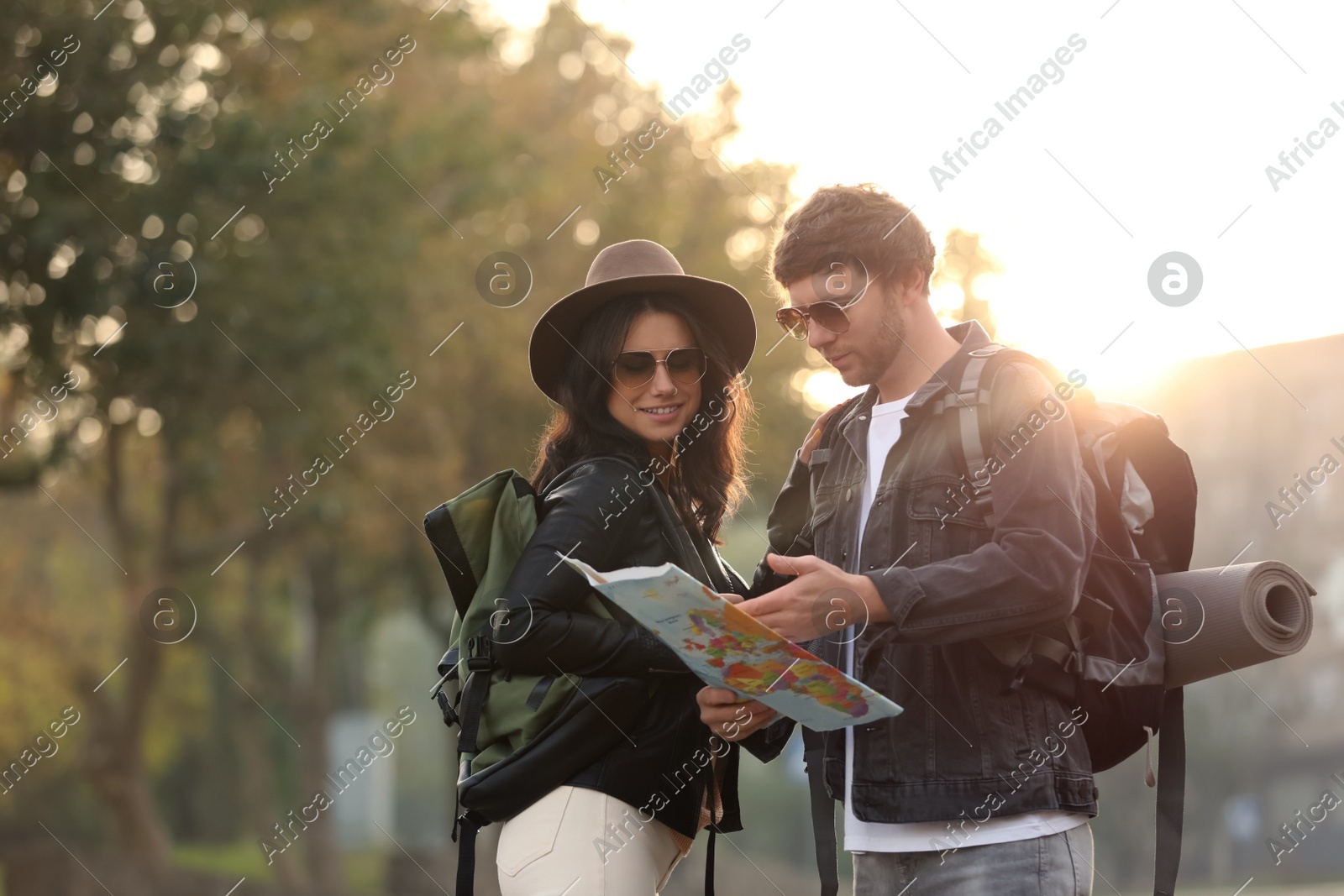 Couple of travelers with map on city street Photo of Couple of travelers with map on city street