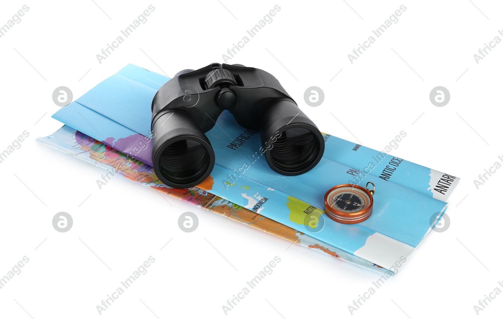 Modern binoculars, compass and map on white background Photo of Modern binoculars, compass and map on white background