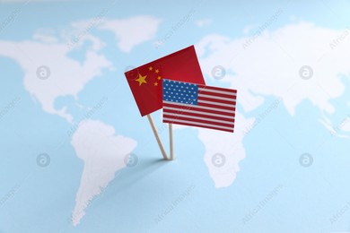 American and Chinese flags on world map. Trade war concept Photo of American and Chinese flags on world map. Trade war concept