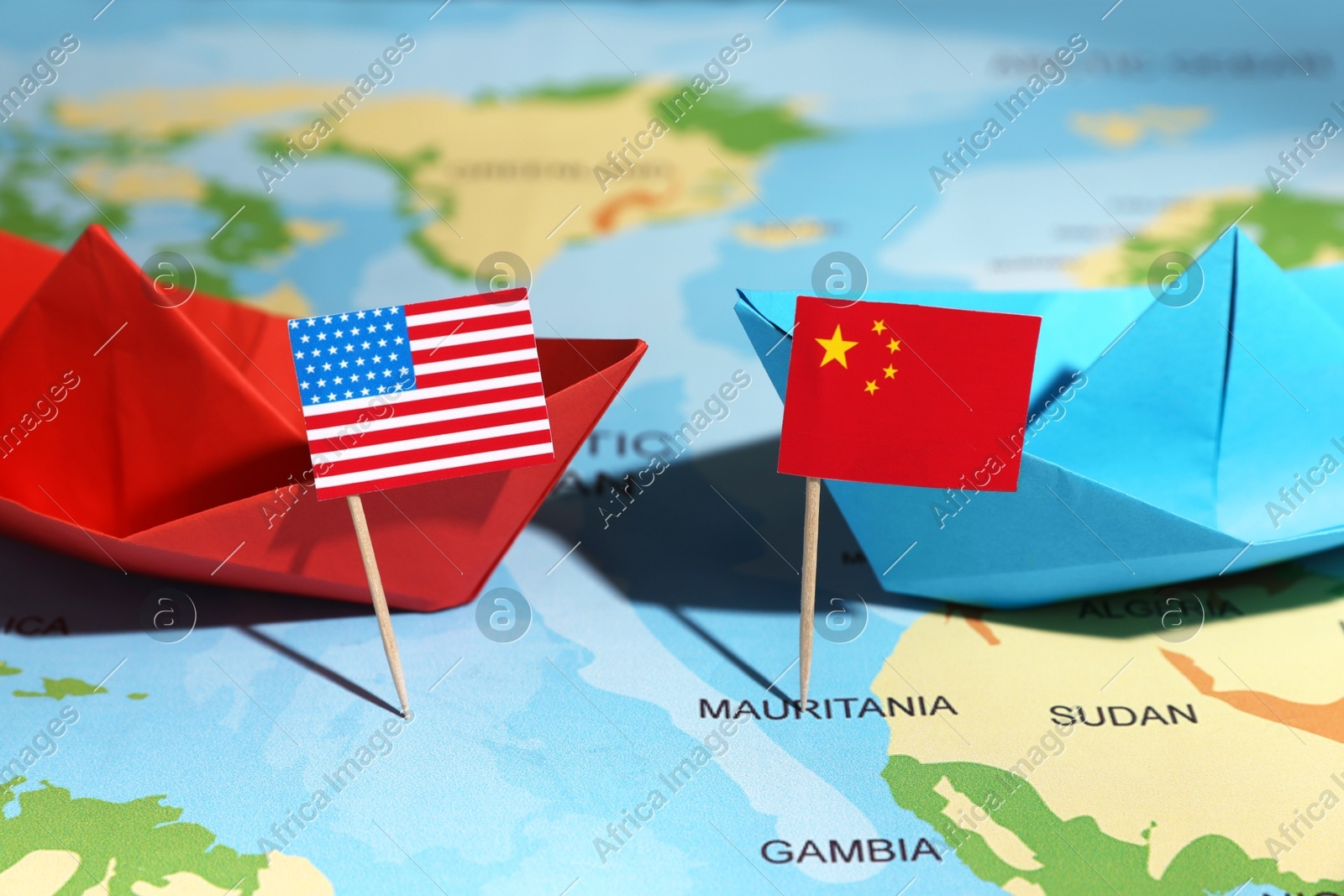 Paper boats with USA and China flags on world map, closeup. Trade war concept Photo of Paper boats with USA and China flags on world map, closeup. Trade war concept