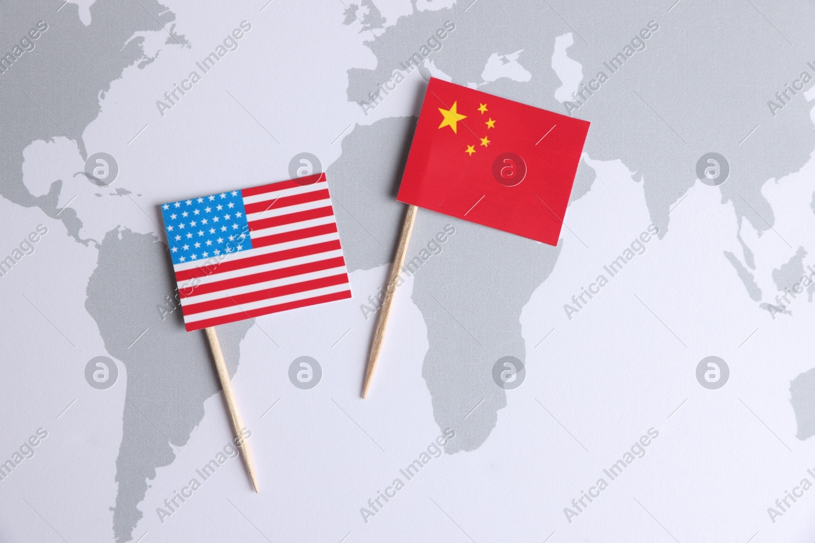 American and Chinese flags on world map, top view. Trade war concept Photo of American and Chinese flags on world map, top view. Trade war concept