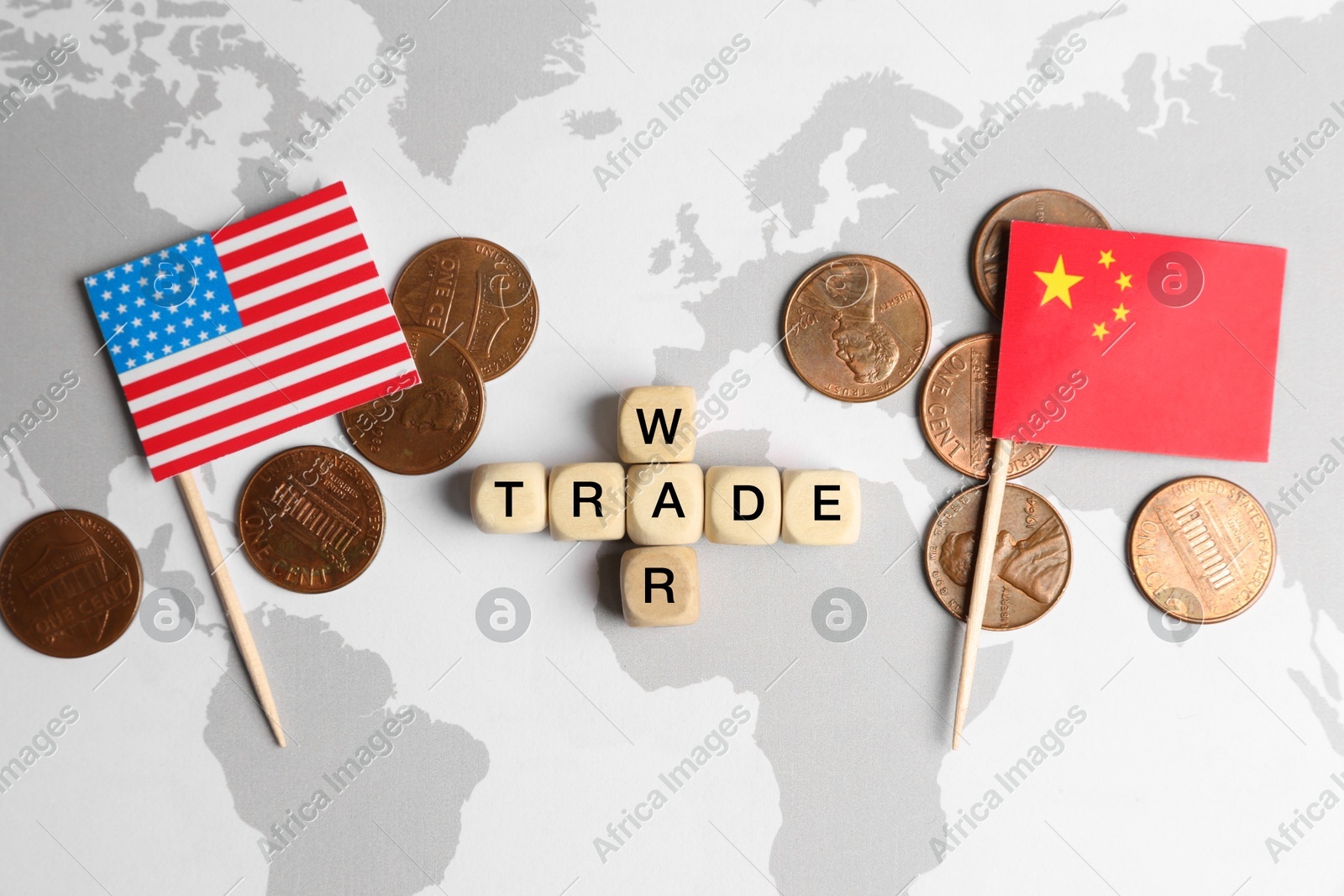 Phrase Trade war made with wooden cubes, coins near USA and China flags on world map, flat lay Photo of Phrase Trade war made with wooden cubes, coins near USA and China flags on world map, flat lay