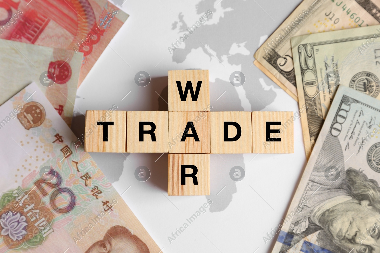 Words Trade war made of wooden cubes, dollar and yuan banknotes on world map, flat lay Photo of Words Trade war made of wooden cubes, dollar and yuan banknotes on world map, flat lay