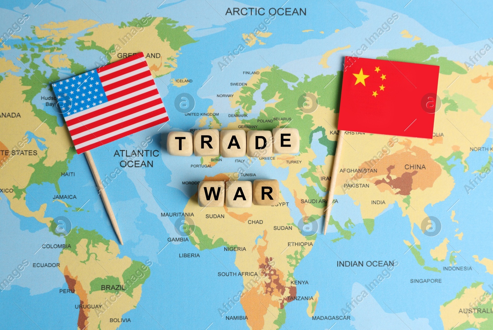 Phrase Trade war made with wooden cubes near USA and China flags on world map, flat lay Photo of Phrase Trade war made with wooden cubes near USA and China flags on world map, flat lay