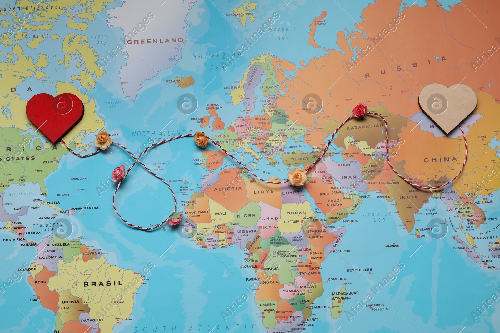 Decorative cord with hearts on world map symbolizing connection in long-distance relationship, top view Photo of Decorative cord with hearts on world map symbolizing connection in long-distance relationship, top view