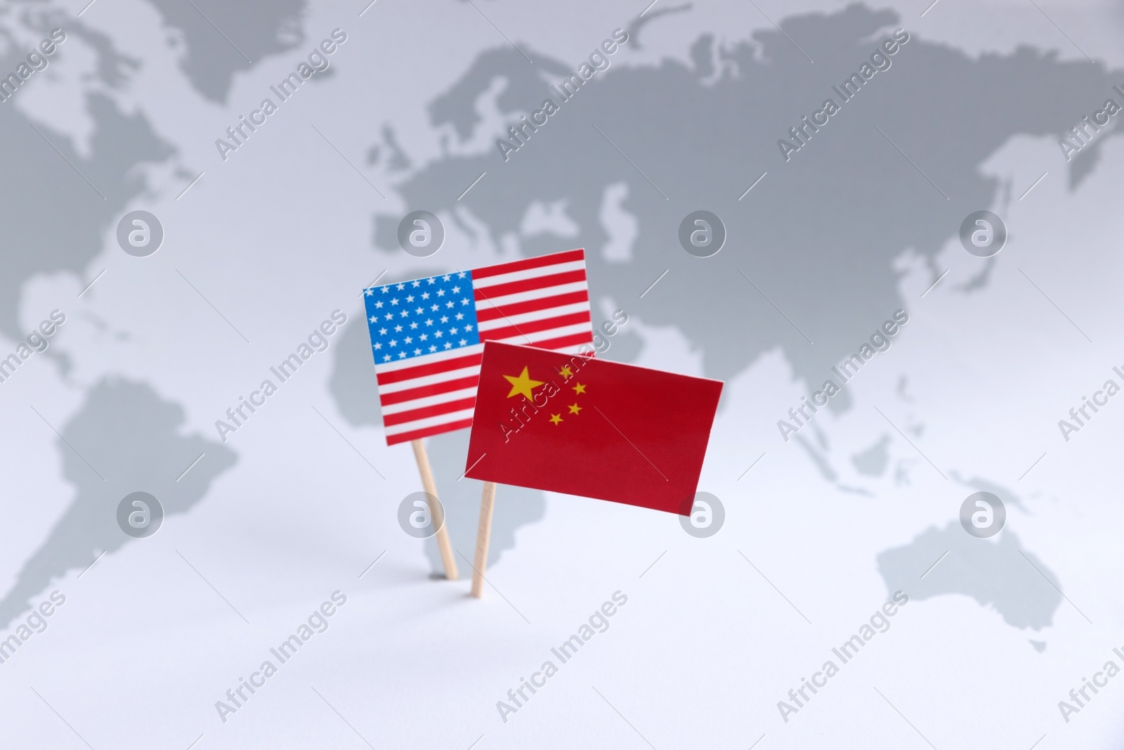 American and Chinese flags on world map. Trade war concept Photo of American and Chinese flags on world map. Trade war concept