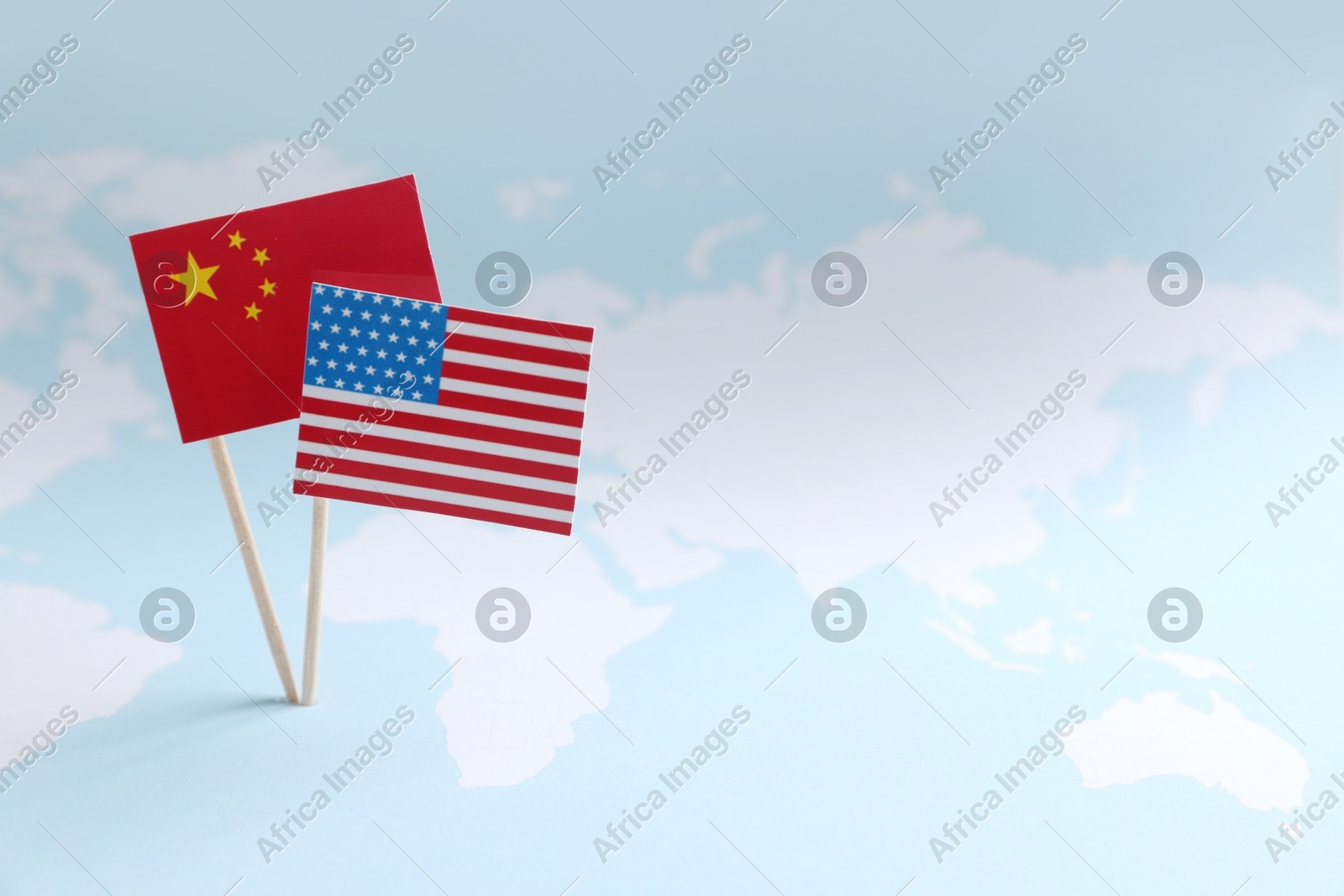 American and Chinese flags on world map, space for text. Trade war concept Photo of American and Chinese flags on world map, space for text. Trade war concept