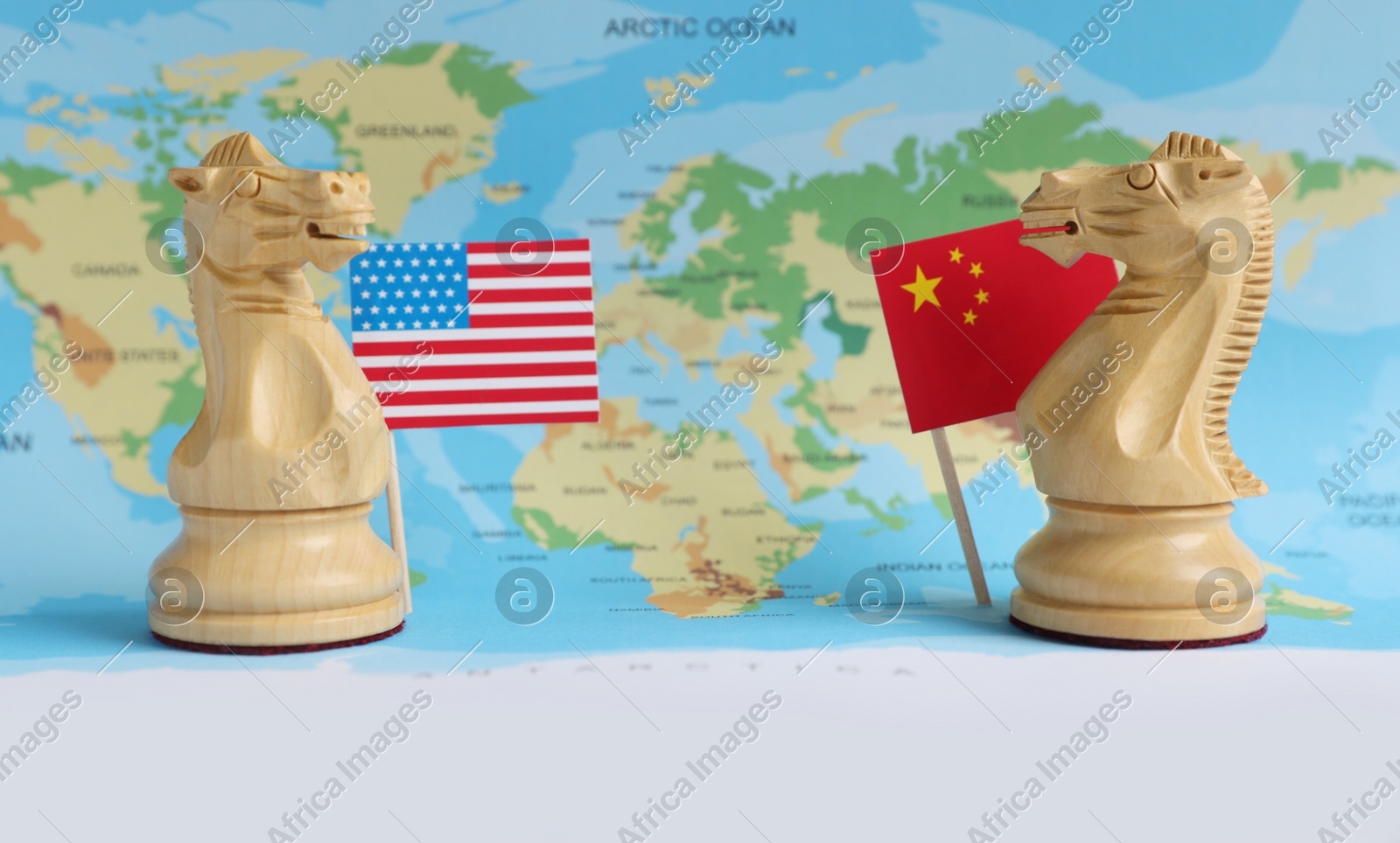 Chess pieces, American and Chinese flags on world map. Trade war concept Photo of Chess pieces, American and Chinese flags on world map. Trade war concept