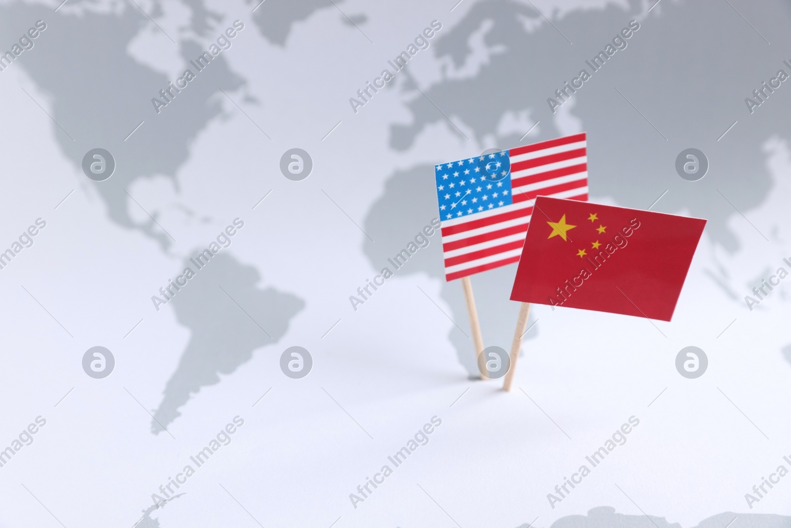 American and Chinese flags on world map, space for text. Trade war concept Photo of American and Chinese flags on world map, space for text. Trade war concept