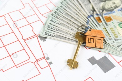 Money and house key on cadastral maps Photo of Money and house key on cadastral maps