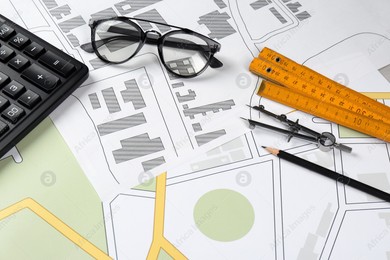 Office stationery on cadastral maps of territory with buildings Photo of Office stationery on cadastral maps of territory with buildings