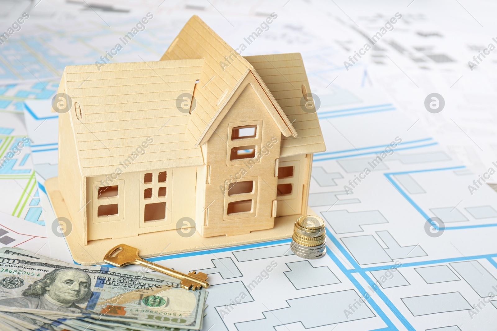 Money, key and house model on cadastral map Photo of Money, key and house model on cadastral map