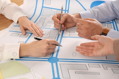 Professional cartographers working with cadastral map at table, closeup Photo of Professional cartographers working with cadastral map at table, closeup
