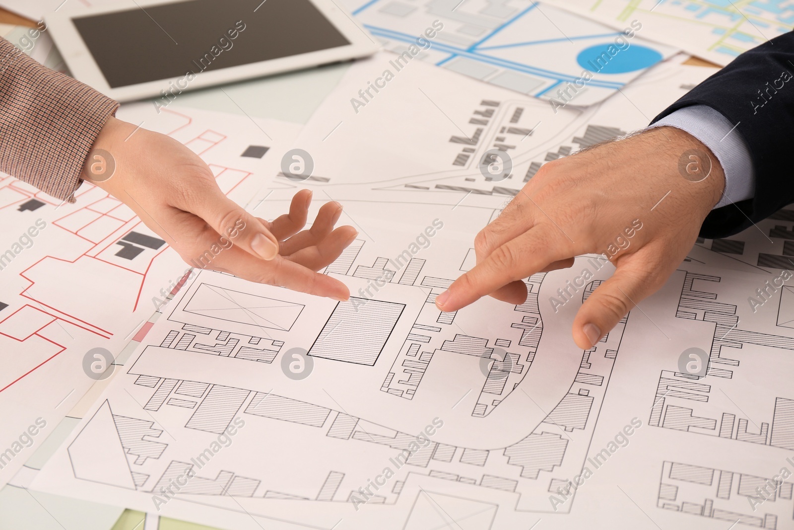 Professional cartographers working with cadastral map at table, closeup Photo of Professional cartographers working with cadastral map at table, closeup