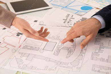 Professional cartographers working with cadastral map at table, closeup Photo of Professional cartographers working with cadastral map at table, closeup