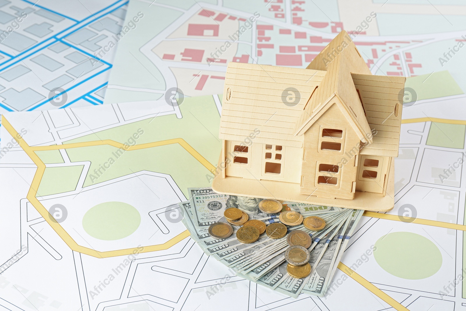 Money and house model on cadastral maps Photo of Money and house model on cadastral maps