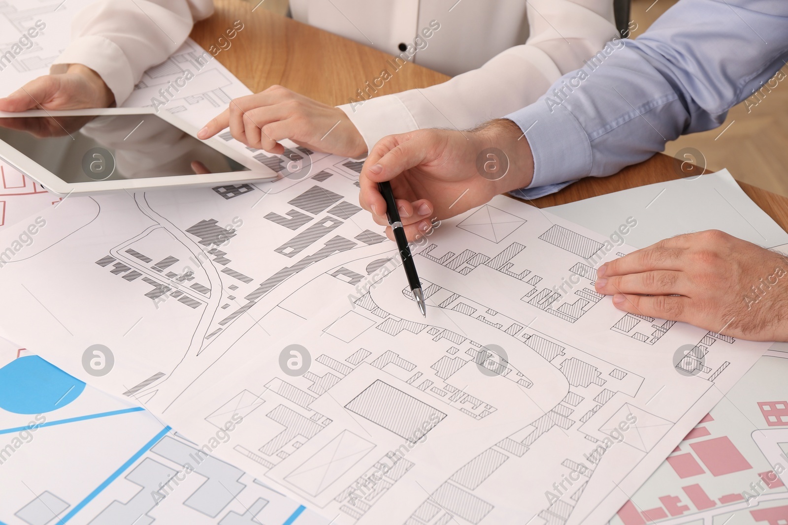 Professional cartographers working with cadastral map at table, closeup Photo of Professional cartographers working with cadastral map at table, closeup