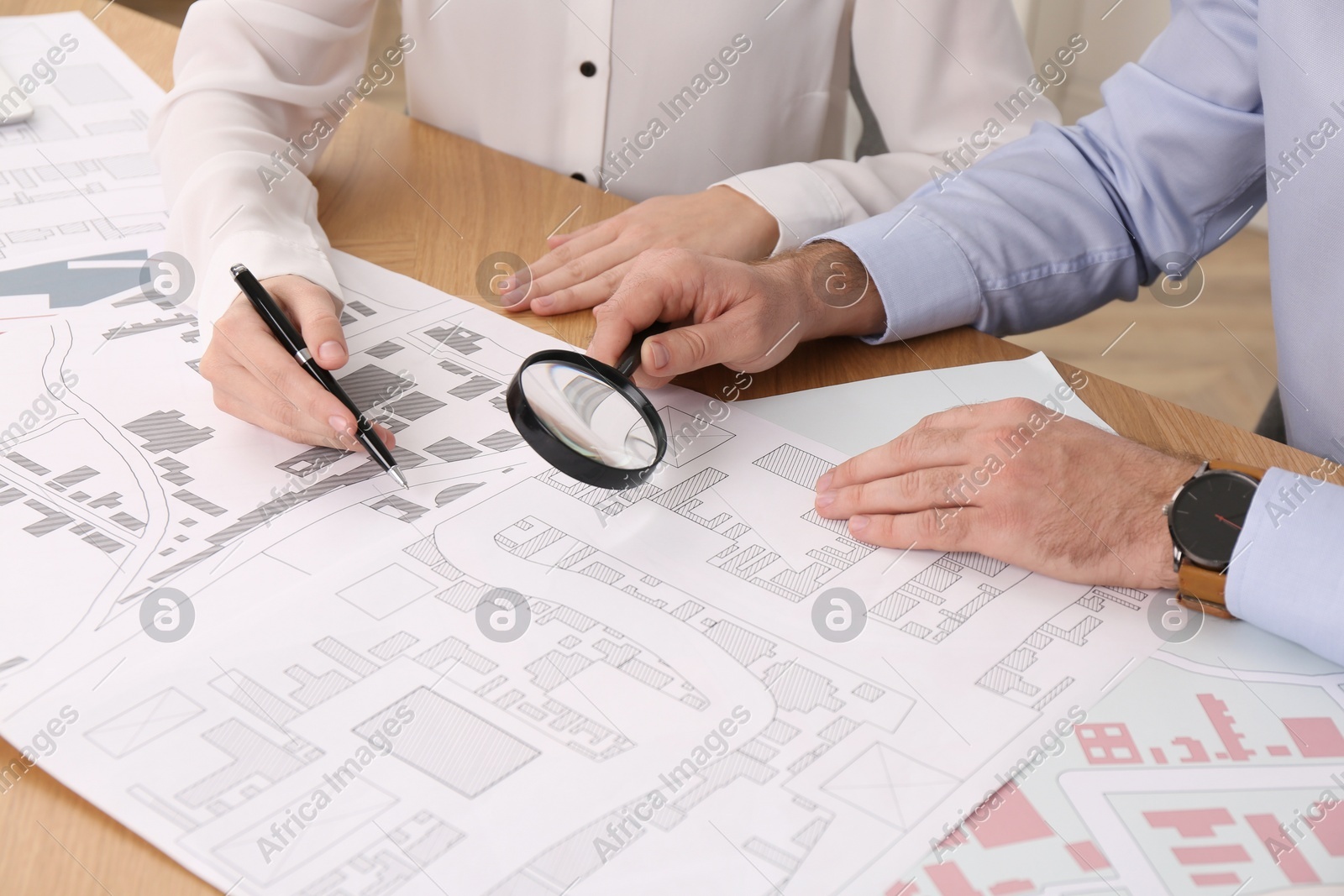 Professional cartographers working with cadastral map at table, closeup Photo of Professional cartographers working with cadastral map at table, closeup