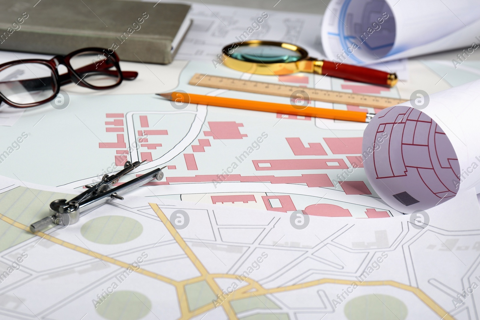 Office stationery and eyeglasses on cadastral maps of territory with buildings Photo of Office stationery and eyeglasses on cadastral maps of territory with buildings