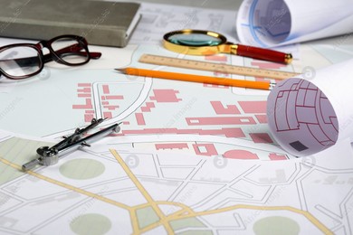 Office stationery and eyeglasses on cadastral maps of territory with buildings Photo of Office stationery and eyeglasses on cadastral maps of territory with buildings