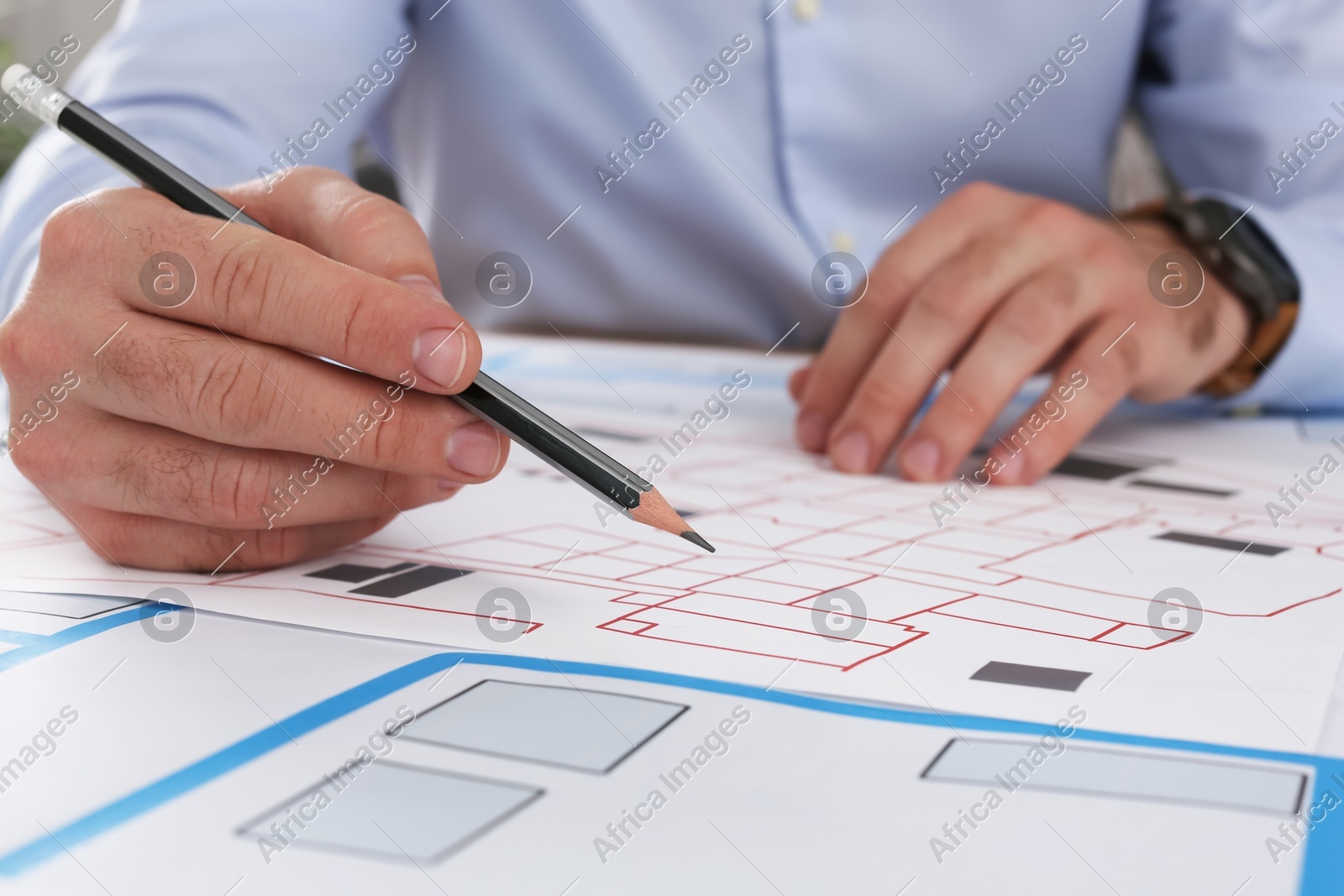 Professional cartographer working with cadastral map at table, closeup Photo of Professional cartographer working with cadastral map at table, closeup