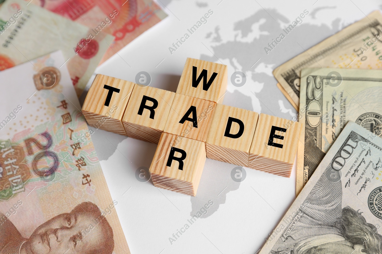 Words Trade war made of wooden cubes, dollar and yuan banknotes on world map, above view Photo of Words Trade war made of wooden cubes, dollar and yuan banknotes on world map, above view