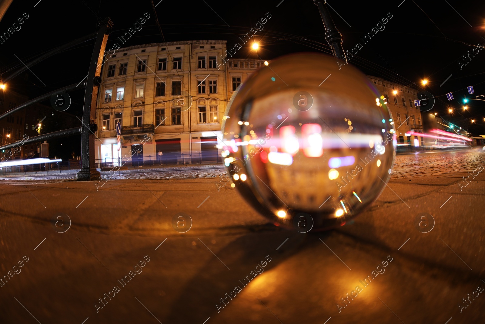 Crystal ball on asphalt road at night, selective focus. Wide-angle lens Photo of Crystal ball on asphalt road at night, selective focus. Wide-angle lens