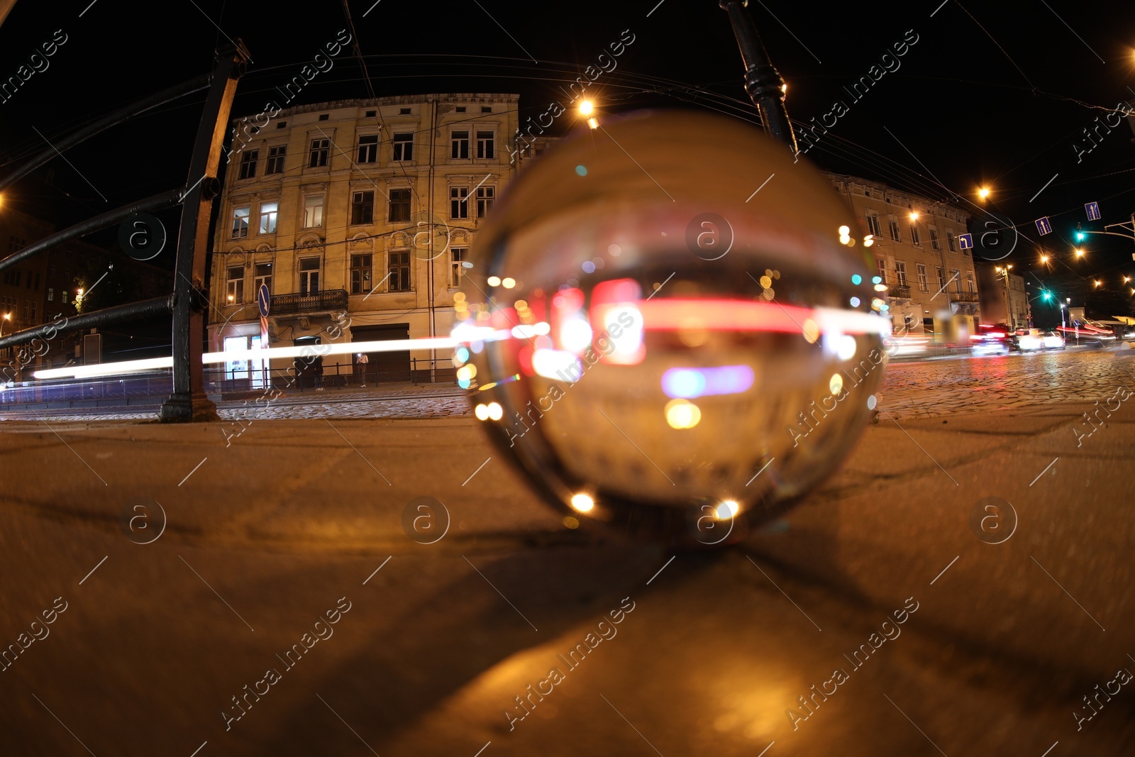 Crystal ball on asphalt road at night, selective focus. Wide-angle lens Photo of Crystal ball on asphalt road at night, selective focus. Wide-angle lens