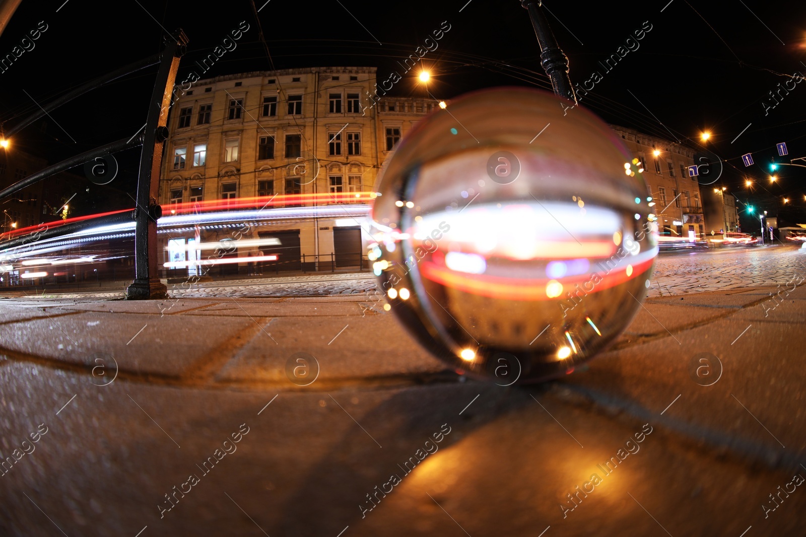 Crystal ball on asphalt road at night, selective focus. Wide-angle lens Photo of Crystal ball on asphalt road at night, selective focus. Wide-angle lens