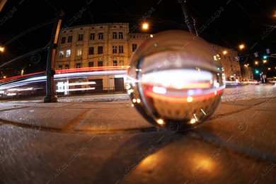 Crystal ball on asphalt road at night, selective focus. Wide-angle lens Photo of Crystal ball on asphalt road at night, selective focus. Wide-angle lens