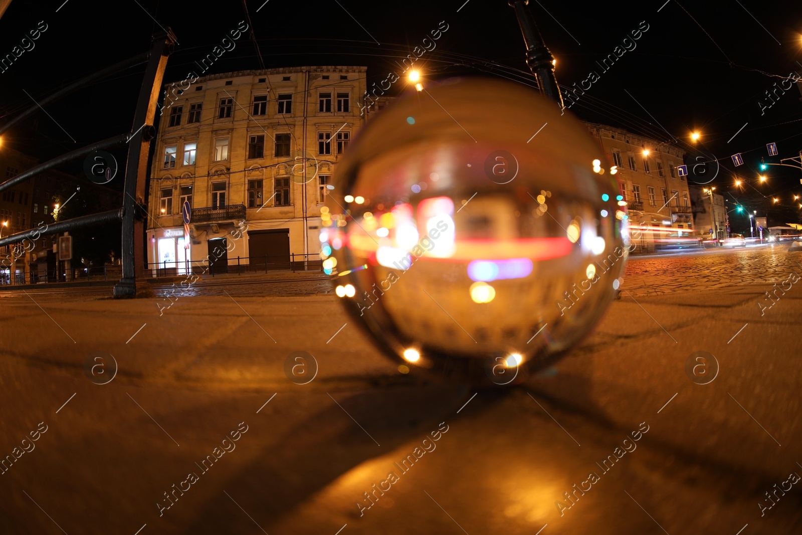 Crystal ball on asphalt road at night, selective focus. Wide-angle lens Photo of Crystal ball on asphalt road at night, selective focus. Wide-angle lens