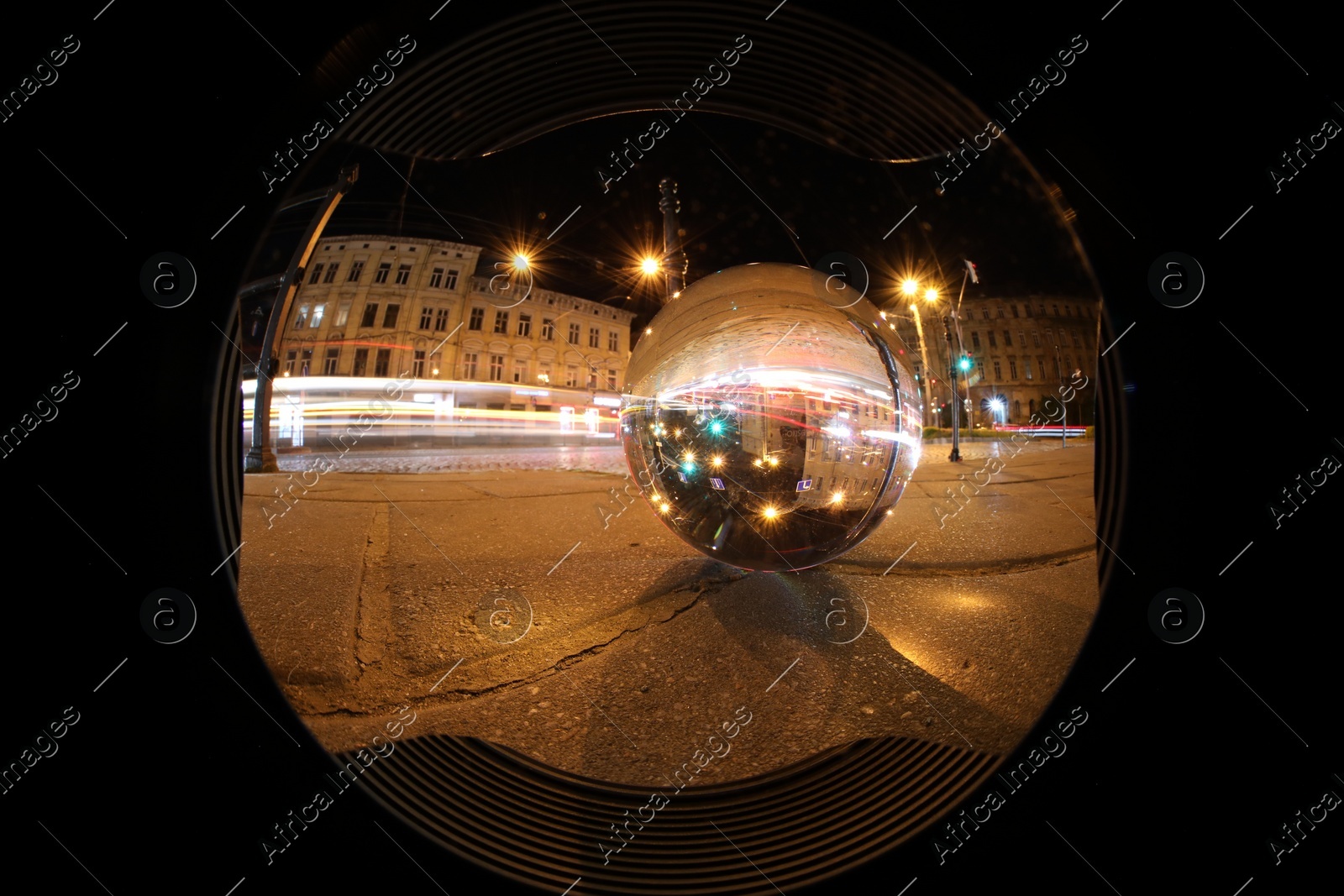 Crystal ball on asphalt road at night, wide-angle lens Photo of Crystal ball on asphalt road at night, wide-angle lens