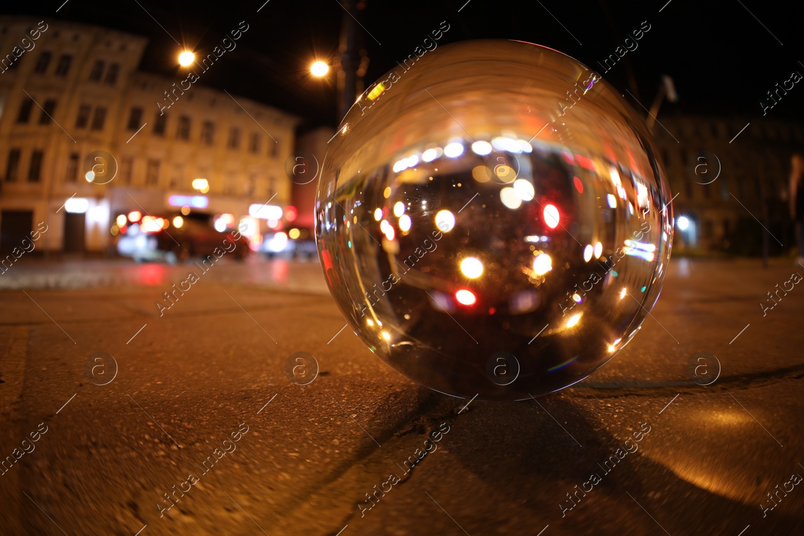 Crystal ball on asphalt road at night. Wide-angle lens Photo of Crystal ball on asphalt road at night. Wide-angle lens