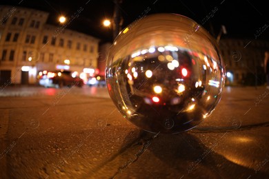 Crystal ball on asphalt road at night. Wide-angle lens Photo of Crystal ball on asphalt road at night. Wide-angle lens