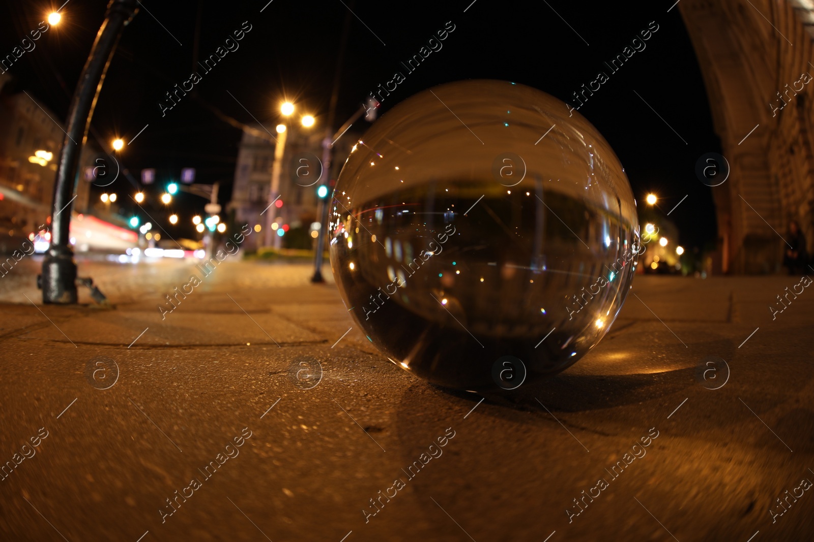 Crystal ball on asphalt road at night. Wide-angle lens Photo of Crystal ball on asphalt road at night. Wide-angle lens