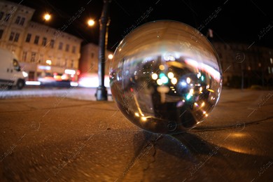 Crystal ball on asphalt road at night. Wide-angle lens Photo of Crystal ball on asphalt road at night. Wide-angle lens