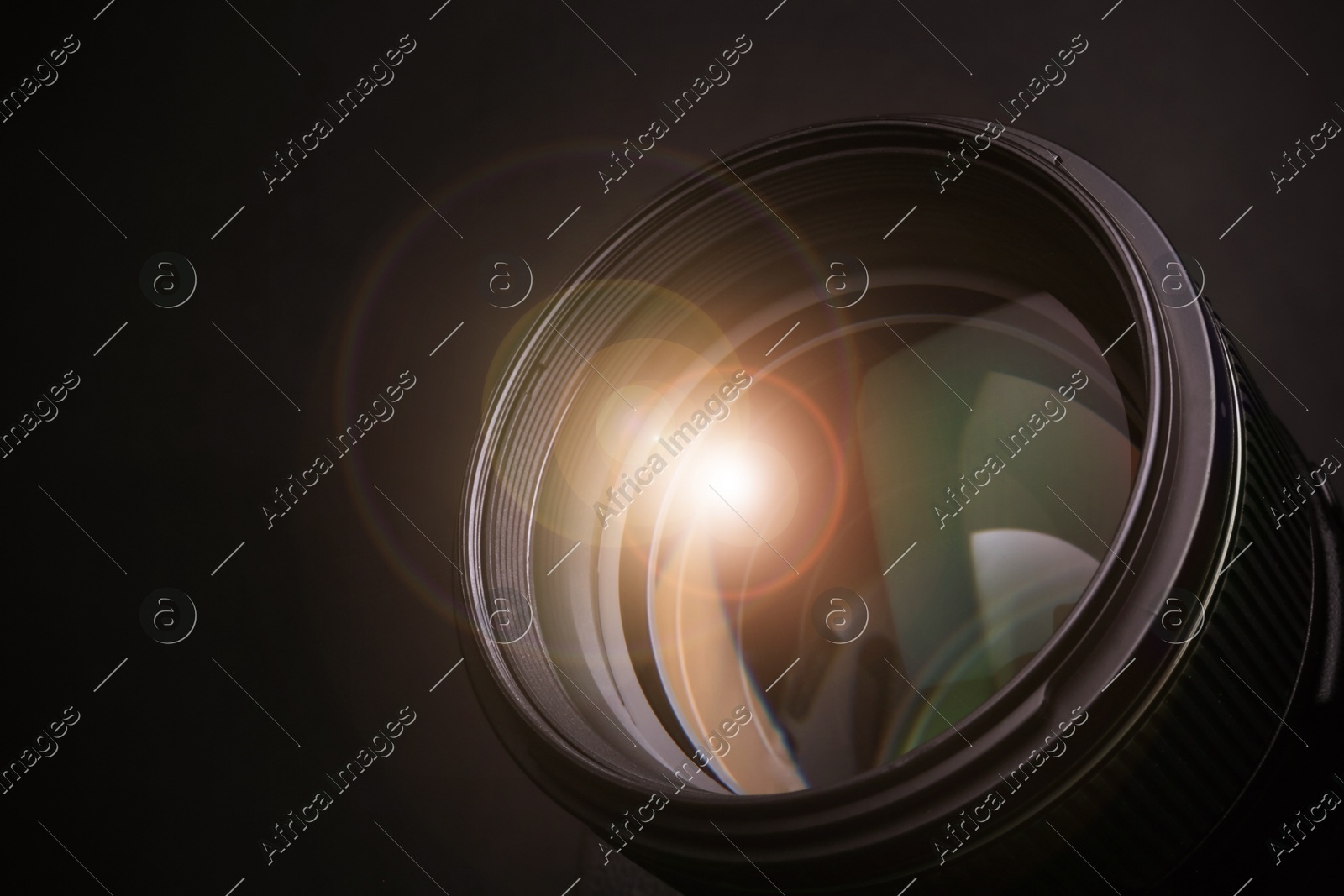 Modern camera lens on black background, closeup Image of Modern camera lens on black background, closeup