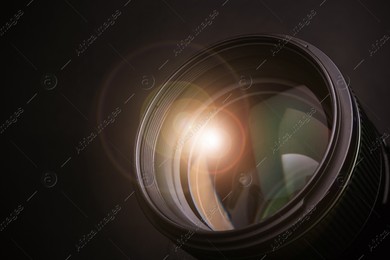 Modern camera lens on black background, closeup Image of Modern camera lens on black background, closeup
