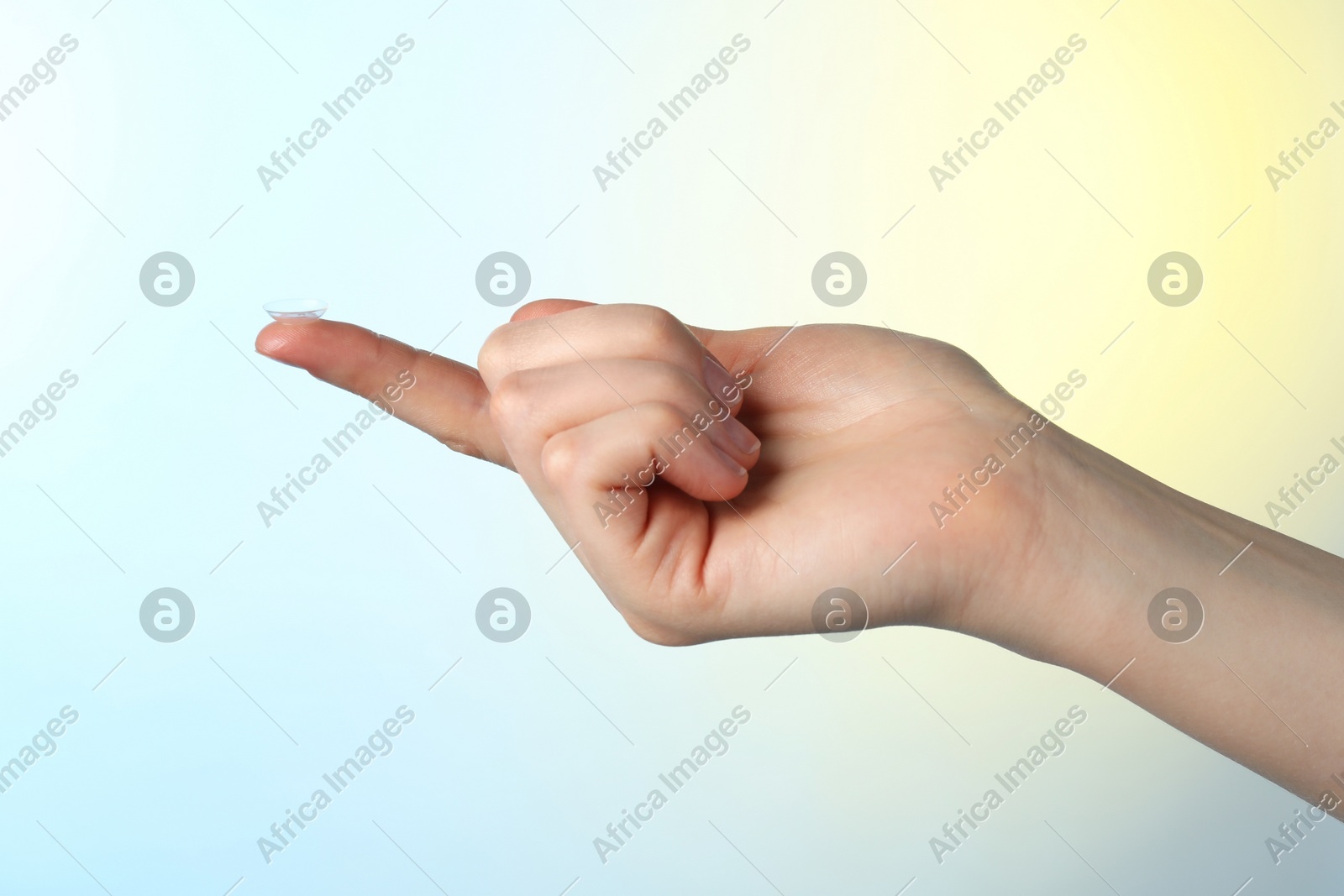 Woman holding contact lens on color background, closeup Photo of Woman holding contact lens on color background, closeup