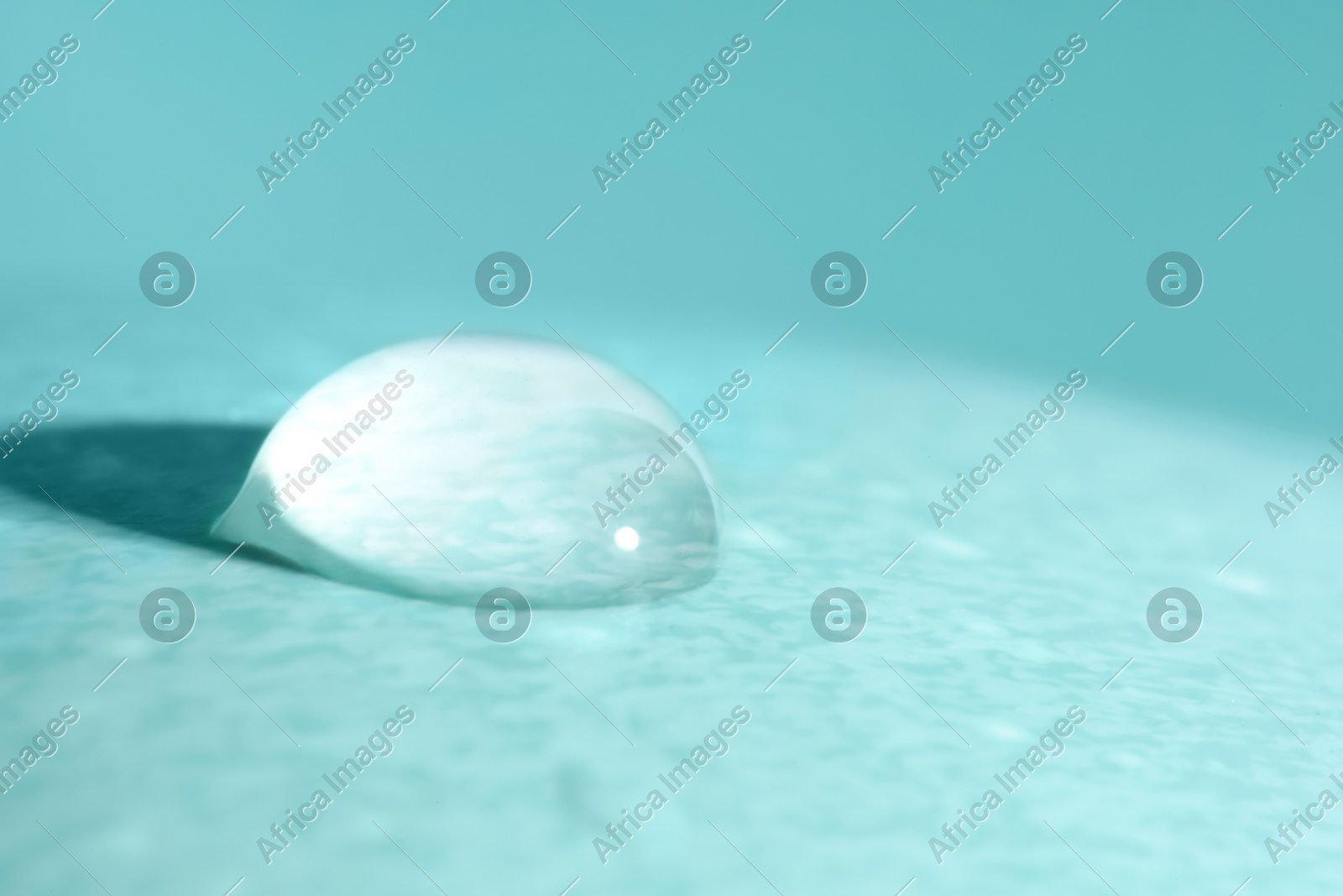 Macro photo of water drop on turquoise background Photo of Macro photo of water drop on turquoise background
