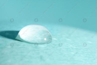Macro photo of water drop on turquoise background Photo of Macro photo of water drop on turquoise background