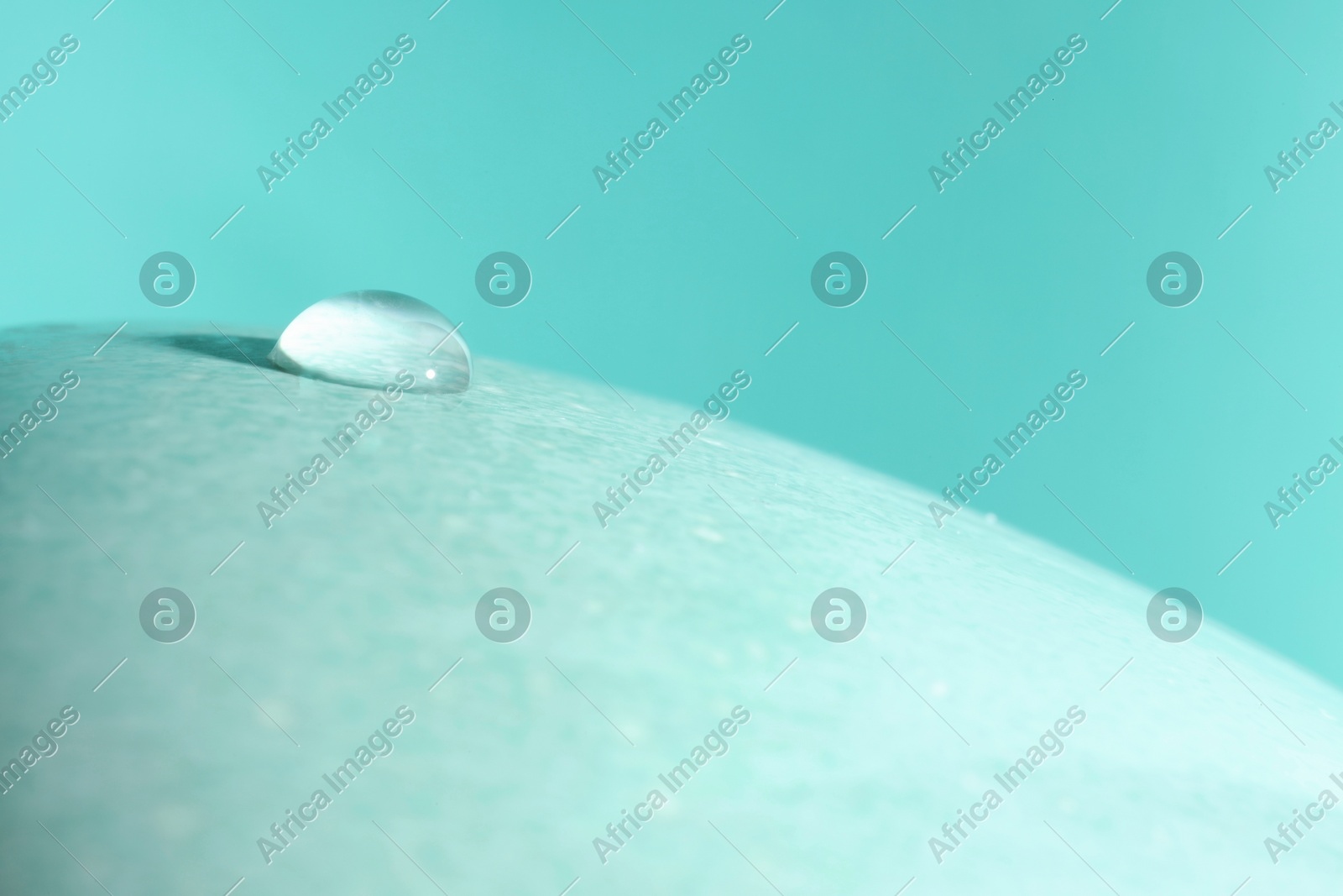 Macro photo of water drop on turquoise background. Space for text Photo of Macro photo of water drop on turquoise background. Space for text